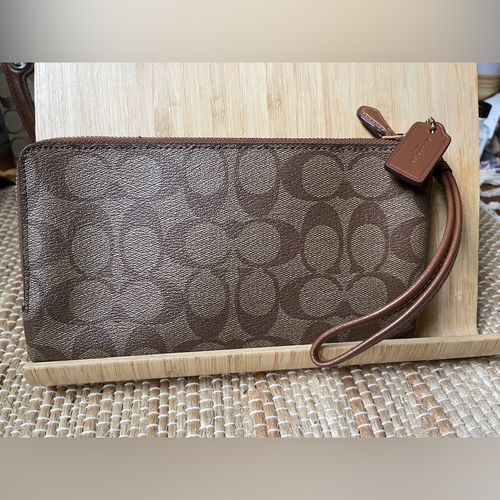 Coach clutch w/wrist strap. 2 zip pockets 5 x 8